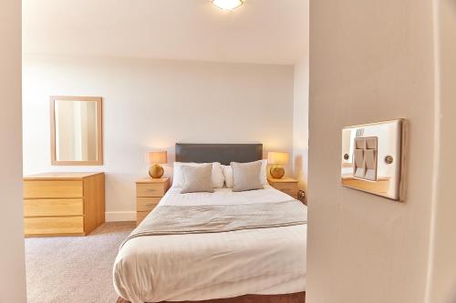 sypialnia z dużym łóżkiem i lustrem w obiekcie Black Friars - Properties Unique w mieście Newcastle upon Tyne
