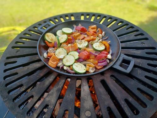 a pan of vegetables cooking on a grill at Apartmány u vleku in Karlova Studánka