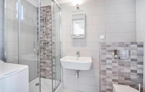 a white bathroom with a sink and a shower at Nice Home In Sianozety With Kitchen in Sianozety