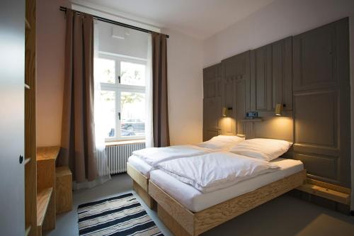 a bedroom with a large bed and a window at Schillinger-Berlin am Tempelhofer Feld in Berlin