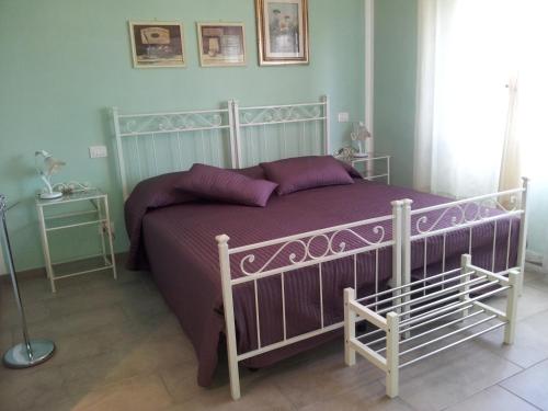 a bedroom with a bed with a purple bedspread at Nonna Anita Palace Narni in Narni