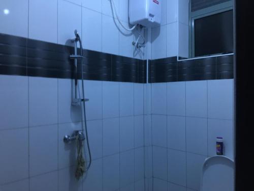 a bathroom with a shower with a toilet and a window at J&R - Lovely two bedroom apartment in Jinja. in Jinja