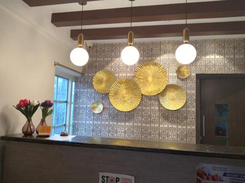 a kitchen with yellow paper umbrellas on the wall at Diviyum Manor in Port Blair