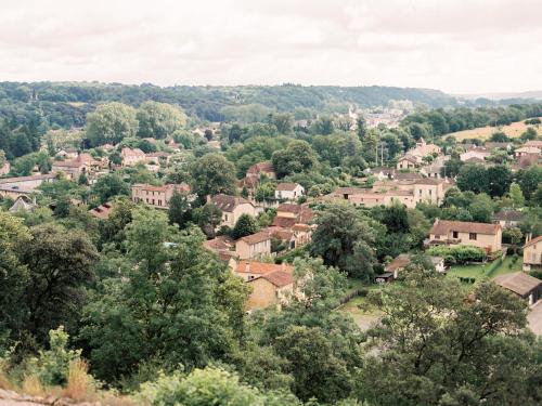 a view of a small town with trees and houses at Gîtes du Château Mont d'Onel in Couze-et-Saint-Front