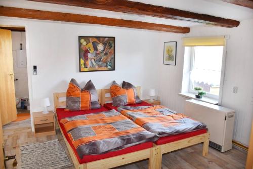 a bedroom with a large bed with orange pillows at Apartment 5 Langelsheim Harz in Langelsheim
