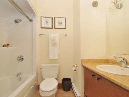 a bathroom with a white toilet and a sink at Just Listed! Gorgeous Luxury 2 Bedroom, 2 Bath Condo In Old Town Victoria in Victoria