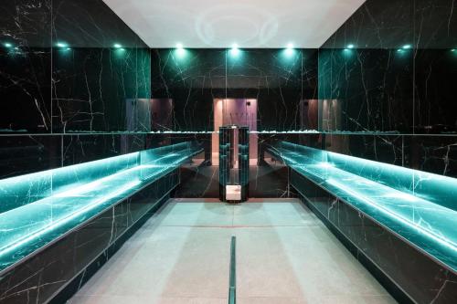 an empty subwayomach with green tile walls and escalators at Small & Beautiful Hotel Gnaid in Tirolo