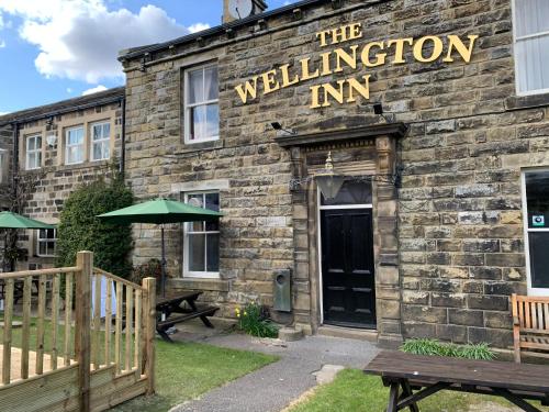 a stone building with a sign that reads the wellington inn at Wellington Inn in Harrogate