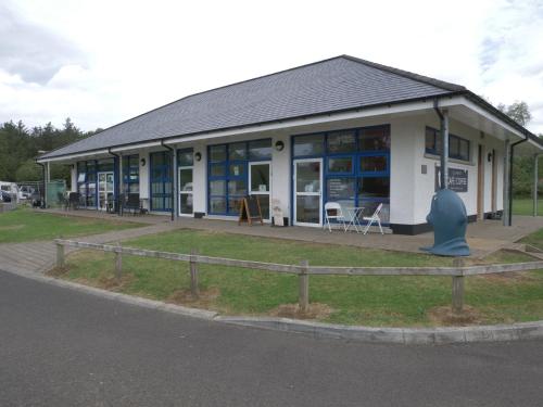 a building with a blue object in front of it at Vivienne in Ballymoney