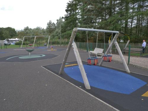 a playground with two swings and a swing at Vivienne in Ballymoney
