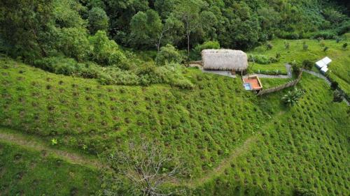 an aerial view of a farm house on a hill at Eco Hotel Glamping El Silencio in Santa Rosa de Cabal