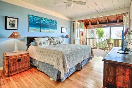 a bedroom with a bed and a balcony at Tropical Paniolo Hale Townhome, Walk to Beach in Maunaloa