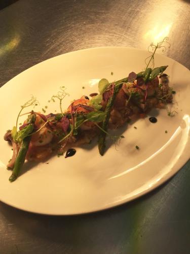 a white plate with a piece of pizza on a table at Wellington Inn in Harrogate