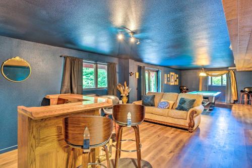 a living room with a couch and a table at 26 Mi to Mount Rainier, Game Room Puyallup Oasis in Puyallup