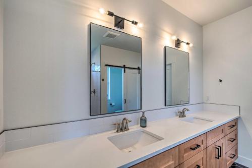 a bathroom with two sinks and two mirrors at Picturesque Moses Lake House with Boating Dock in Moses Lake
