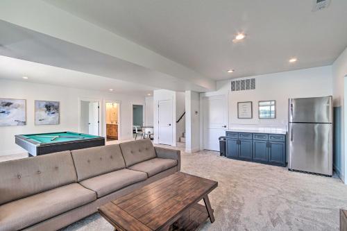 a living room with a couch and a pool table at Picturesque Moses Lake House with Boating Dock in Moses Lake