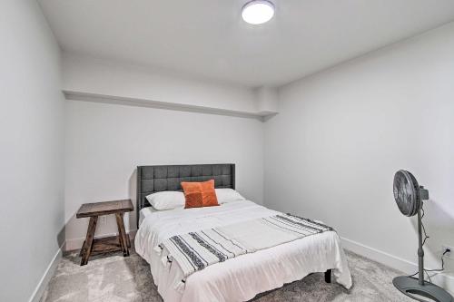 a bedroom with a bed with an orange pillow and a desk at Picturesque Moses Lake House with Boating Dock in Moses Lake