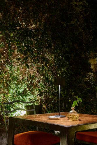 a wooden table with a vase on top of it at Casa Howard Firenze - Residenza d'Epoca in Florence