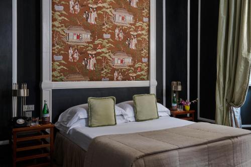 a bedroom with a bed with a large painting on the wall at Casa Howard Firenze - Residenza d'Epoca in Florence
