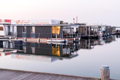 a house boat docked at a marina on the water at Hausboot EL-SOL in Braunsbedra