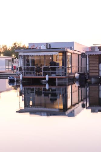 a small boat is docked at a marina at Hausboot EL-SOL in Braunsbedra