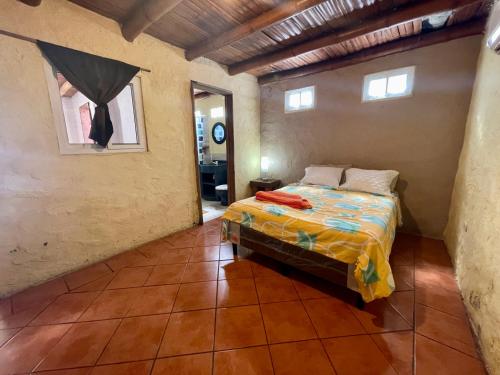 a bedroom with a bed in a room at Johnnys Place Hotel in Monterrico