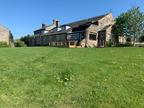 a large house with a grass field in front of it at Wellington Inn in Harrogate