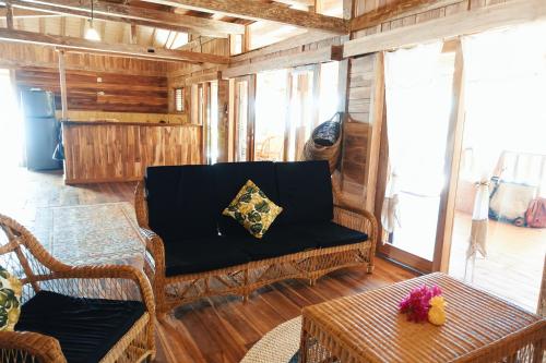 a living room with a couch and a table at villa gilimakyah in Gili Air