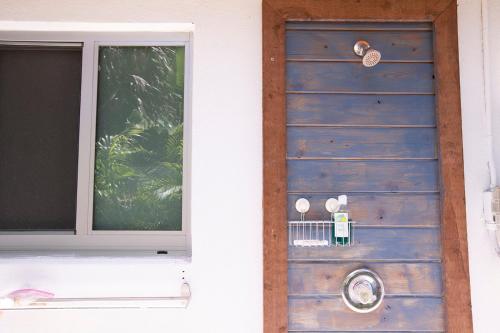 a blue door with a window on a house at Casa Limonada Boutique Motel in Sarasota