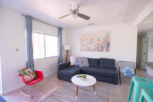 a living room with a couch and a table at Casa Limonada Boutique Motel in Sarasota