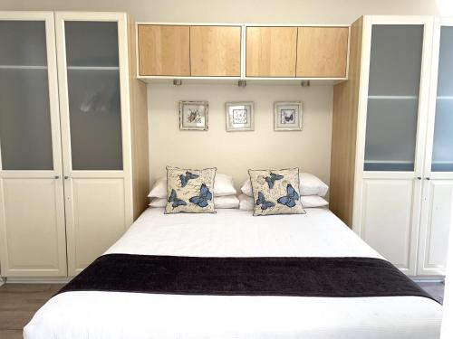 a bedroom with a large white bed with two pillows at Jedda on Jersey 6 in Perth