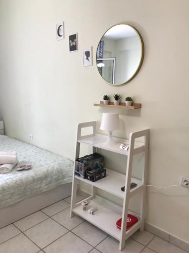 a bedroom with a white shelf and a mirror at Kozani elegant. Διαμέρισμα στο κέντρο της κοζάνης in Kozani