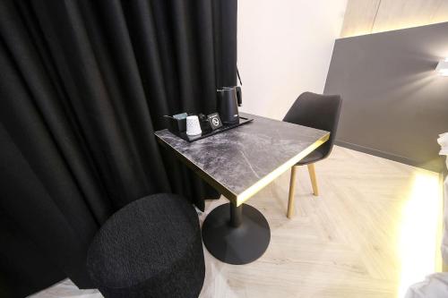 a room with a table and a black curtain at Masan First Class Hotel in Changwon