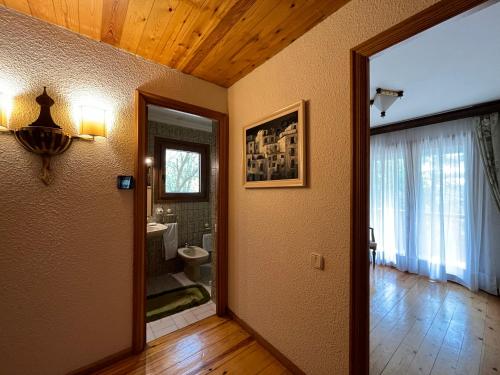 a hallway with a bathroom with a toilet and a mirror at Prades Cal Rueda in Prades