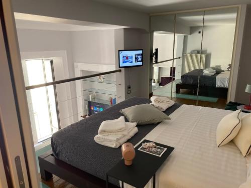 a bedroom with a large bed with a mirror at Portacatena Suite in Salerno