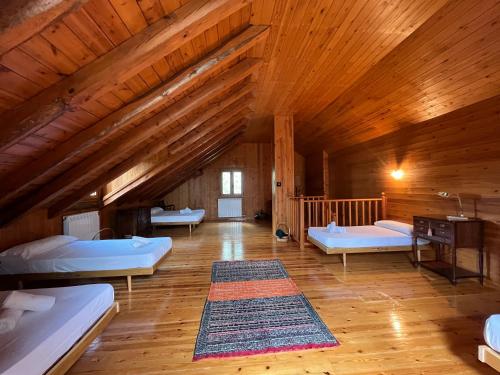 a large room with two beds and a wooden ceiling at Prades Cal Rueda in Prades