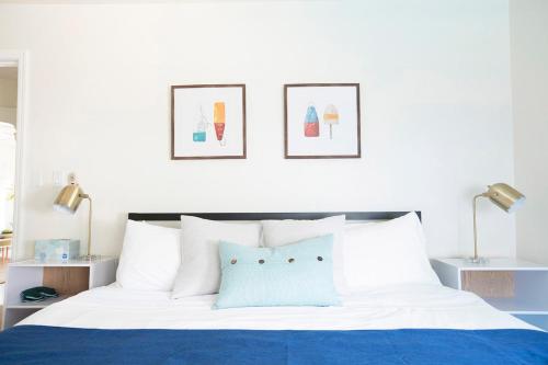 - une chambre avec un lit bleu et blanc et 2 lampes dans l'établissement Casa Limonada Boutique Motel, à Sarasota