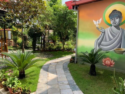 a mural of a buddha with a butterfly at Hotel ABC, Boutique Hotel in Pokhara in Pokhara