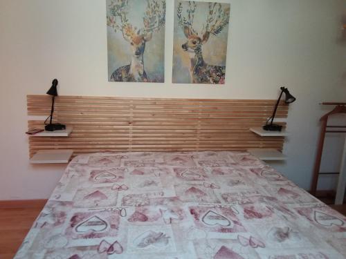 um quarto com uma cama e duas pinturas na parede em A Cento Metri dal Mare em Senigallia
