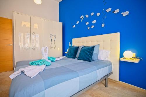 a blue bedroom with a large bed with blue walls at BlUE LAGOON in Costa Calma