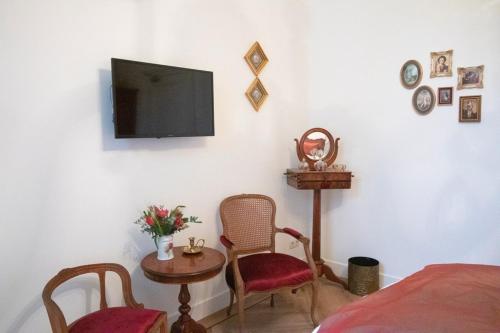 a room with a tv and a table and chairs at Hotellerie Het Wapen Van Athlone in De Steeg