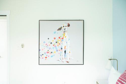 a painting of a woman with balloons on a wall at Casa Limonada Boutique Motel in Sarasota