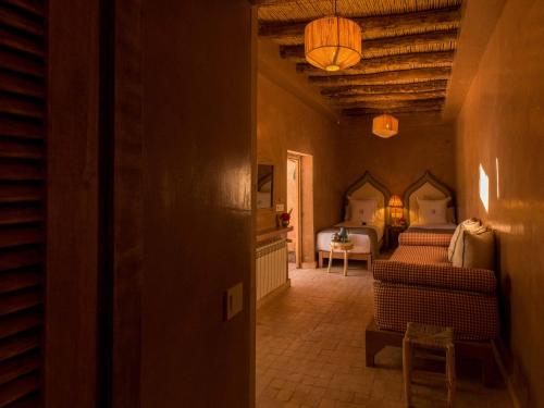a hallway with a bedroom with a bed and a table at CASA ABRACADABRA in Marrakech