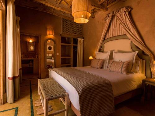a bedroom with a large bed with a canopy at CASA ABRACADABRA in Marrakech