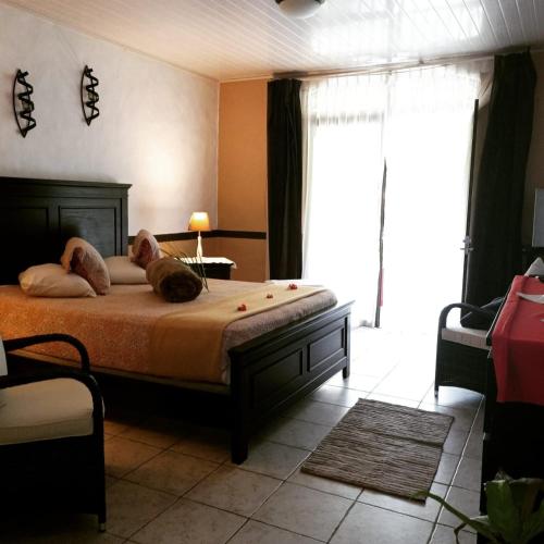 a bedroom with a bed with two dogs laying on it at Hotel Belvedere Playa Samara Costa Rica in Sámara