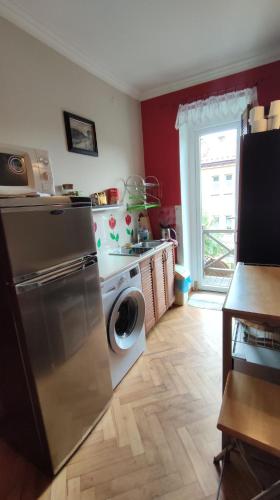 a kitchen with a refrigerator and a washing machine at Dom Sula in Ustrzyki Dolne