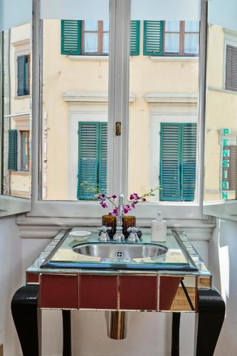 a bathroom sink in a window with a view of a building at Casa Howard Firenze - Residenza d'Epoca in Florence