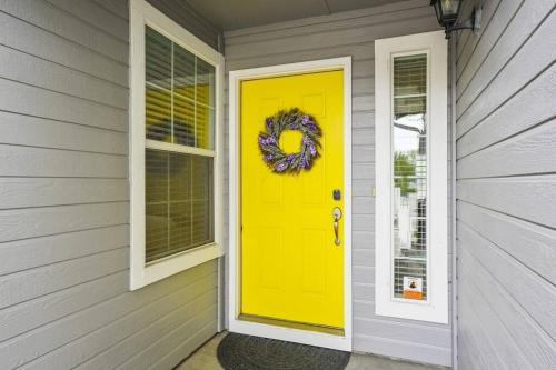 a yellow front door with a wreath on a house at Remodeled, Charming Retreat on the City's Doorstep in Boise