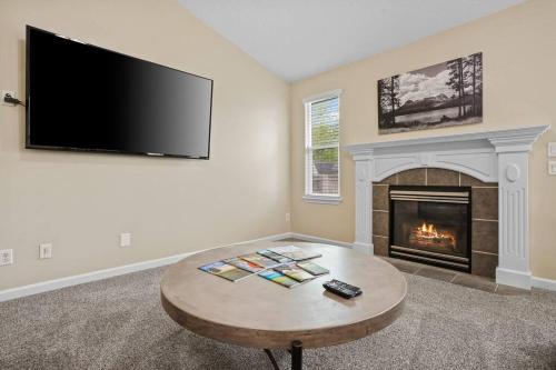 a living room with a fireplace and a flat screen tv at Remodeled, Charming Retreat on the City's Doorstep in Boise