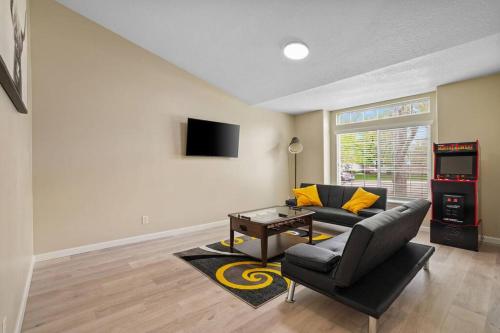 a living room with a black couch and a table at Remodeled, Charming Retreat on the City's Doorstep in Boise
